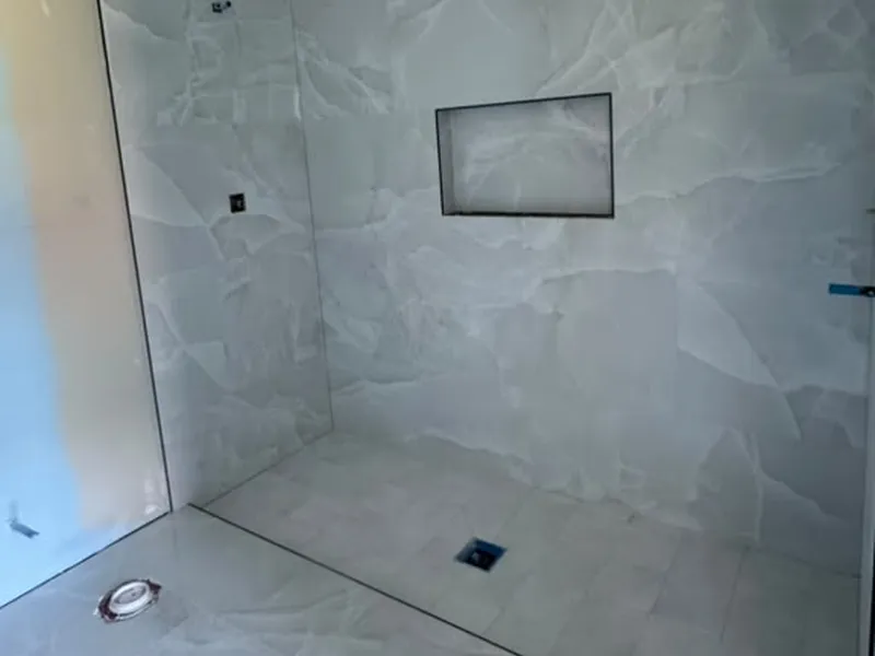 Large-format tile shower with recessed niche and linear drain