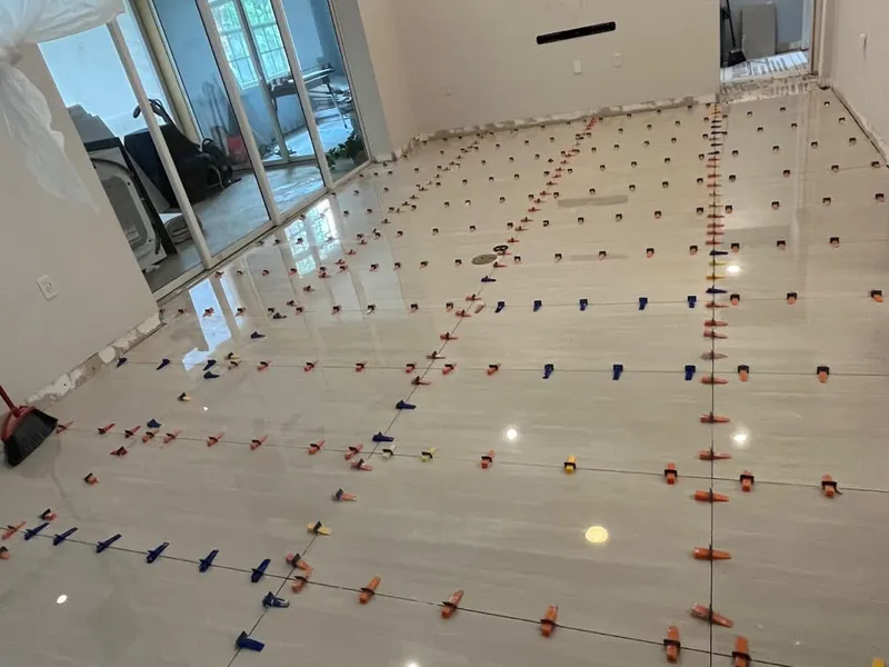 Large porcelain floor tiles being leveled during install