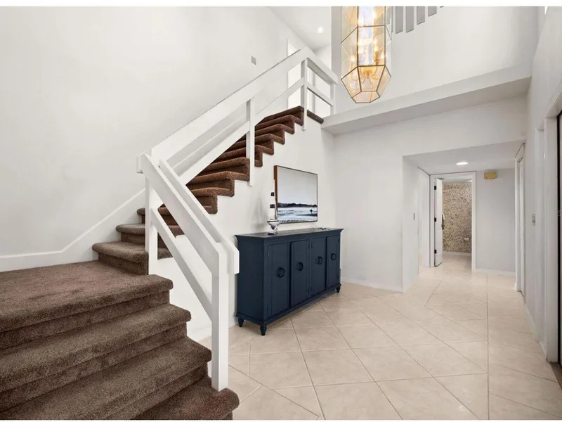 Bright white foyer and staircase freshly painted by Bright Sheep